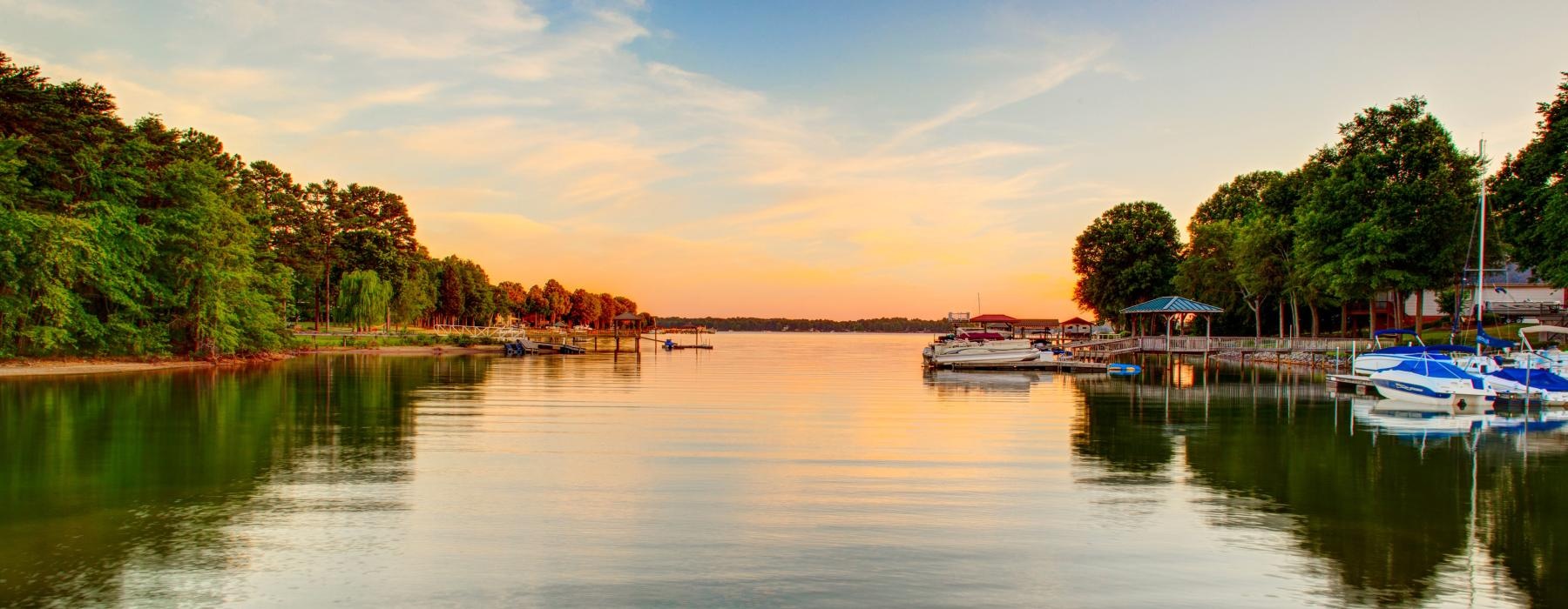 a body of water with boats on it and trees around it