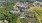 Aerial shot of community with buildings, trees, and lakes, taken at an angle