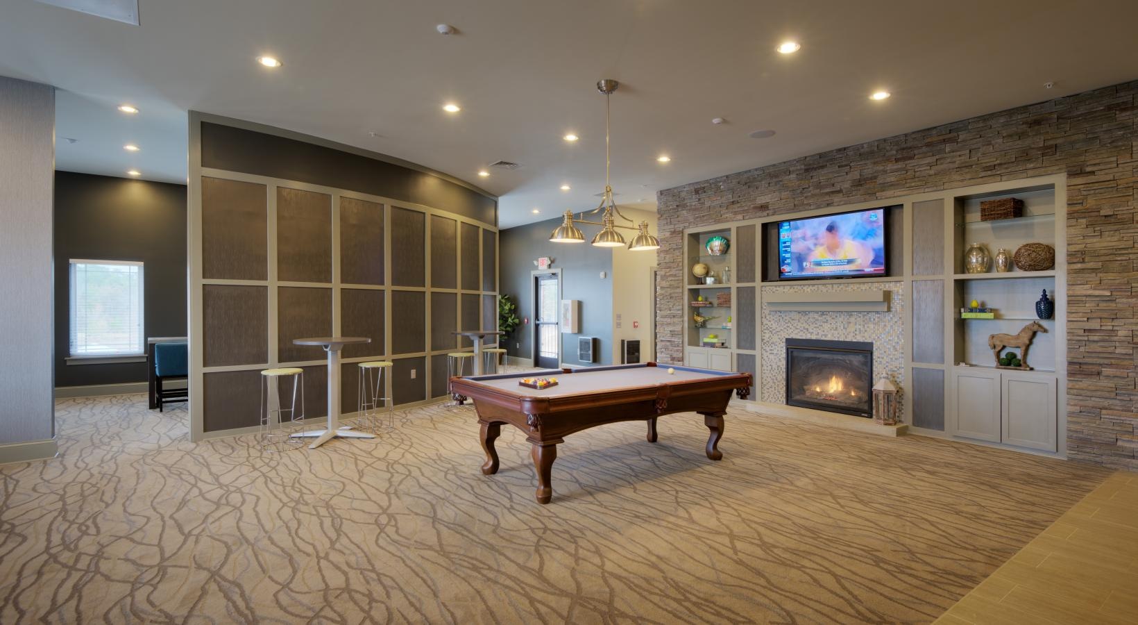 Take advantage of all Langtree at Lake Norman has to offer a room with a table and a fireplace