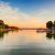 a body of water with boats on it and trees around it