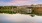 a body of water with buildings and trees around it